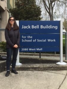 Eleanor Lipov in front of the School of Social Work sign.